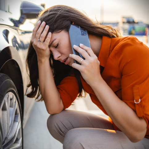 woman in distress with broken down car