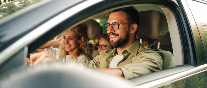 happy family driving car with extended warranty