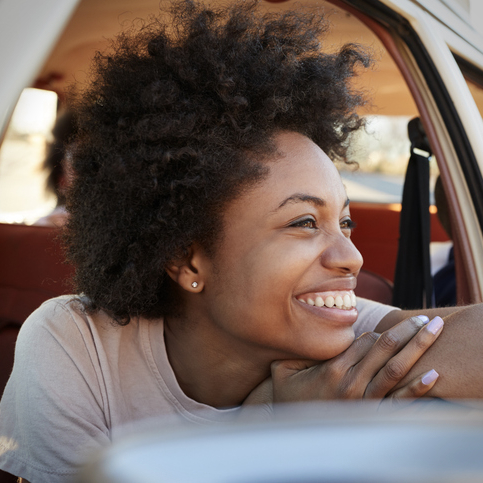 happy woman driving stress free because of extended warranty