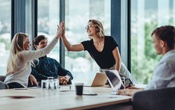 high five at a business board meeting
