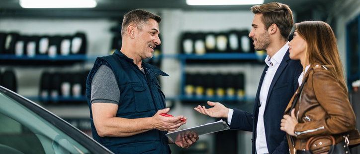happy couple getting car fixed with extended warranty