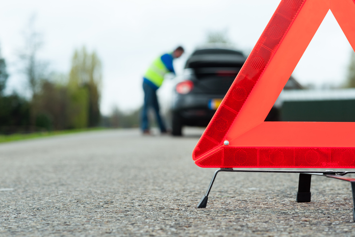 Driver getting roadside assistance with extended warranty